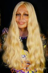 Donatella Versace (b.1955) - Italian born fashion designer who took over the family business after her brother Gianni Versace was murdered in 1997. This bleeched, tanned jetset, plastic surgery loving woman has turned "Versace" into a household name and a multi billion company.